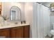 Bathroom featuring wood vanity, an arched mirror, and a bathtub and shower combo at 4706 Cedar Park Trl, Stone Mountain, GA 30083