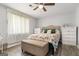 Bright bedroom featuring wood-look floors, ceiling fan, large window, and ample storage at 4706 Cedar Park Trl, Stone Mountain, GA 30083