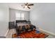 Bedroom with wood-look floors, ceiling fan and unique basketball court themed rug at 4706 Cedar Park Trl, Stone Mountain, GA 30083