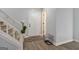 Entryway featuring wood-look floors, carpeted stairs, and a white front door with decorative wreath at 4706 Cedar Park Trl, Stone Mountain, GA 30083