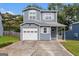 Charming two-story home featuring a covered porch, attached garage, and concrete driveway at 4706 Cedar Park Trl, Stone Mountain, GA 30083