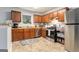 Functional kitchen featuring wood cabinets, stainless steel appliances, and a window above the sink at 4706 Cedar Park Trl, Stone Mountain, GA 30083