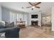 Cozy living room with a fireplace, wood-look floors, and plenty of natural light at 4706 Cedar Park Trl, Stone Mountain, GA 30083