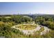 Panoramic aerial view shows mature landscaping, park features, lake, and the Atlanta skyline at 1271 Mackintosh Nw Park # 30, Atlanta, GA 30318