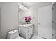 Well-lit bathroom features a vanity with a marble countertop and decorative flowers at 1271 Mackintosh Nw Park # 30, Atlanta, GA 30318