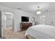 Bright bedroom featuring neutral walls, large TV, and two doorways to other rooms at 1271 Mackintosh Nw Park # 30, Atlanta, GA 30318
