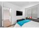Bedroom with a large window, a mounted TV, and a bed with a teal blanket at 1271 Mackintosh Nw Park # 30, Atlanta, GA 30318