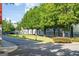 Community green space features lush trees, street lights, sidewalks, and several benches at 1271 Mackintosh Nw Park # 30, Atlanta, GA 30318