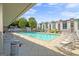Community pool surrounded by lounge chairs, and lush greenery on a sunny day at 1271 Mackintosh Nw Park # 30, Atlanta, GA 30318