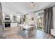 Open-concept dining and kitchen area with sleek white cabinets, stainless appliances, and a modern table at 1271 Mackintosh Nw Park # 30, Atlanta, GA 30318