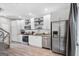 Modern kitchen with stainless steel appliances, white cabinetry and adjacent dining area at 1271 Mackintosh Nw Park # 30, Atlanta, GA 30318