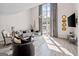 Spacious living room featuring floor-to-ceiling windows, modern decor, and an open layout at 1271 Mackintosh Nw Park # 30, Atlanta, GA 30318