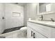 Modern bathroom featuring black and white tile, white cabinets, and quartz countertops at 1914 North Nw Ave, Atlanta, GA 30318