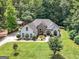 Aerial view of a beautiful property, featuring a well-maintained lawn and verdant surrounding trees at 264 Line Creek Cir, Sharpsburg, GA 30277