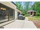 Outdoor patio with grill and walkway leading to a charming red barn-style outbuilding at 264 Line Creek Cir, Sharpsburg, GA 30277