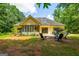 Backyard featuring patio with seating, fire pit, and a view of the house and outbuilding at 264 Line Creek Cir, Sharpsburg, GA 30277