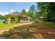 Expansive backyard featuring a covered porch, patio seating, and a well-maintained lawn at 264 Line Creek Cir, Sharpsburg, GA 30277