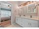Bathroom featuring double vanity with granite countertop, white cabinets and views of a bedroom through an open door at 264 Line Creek Cir, Sharpsburg, GA 30277