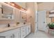 A well-lit bathroom with double sinks, granite countertop, white cabinets and neutral color palette at 264 Line Creek Cir, Sharpsburg, GA 30277