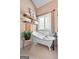 This bathroom has a claw foot tub, white tile surround, wood shelving and ample natural light at 264 Line Creek Cir, Sharpsburg, GA 30277