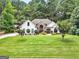 Charming one-story home featuring stone accents, mature landscaping, and a spacious front yard at 264 Line Creek Cir, Sharpsburg, GA 30277