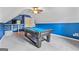 Finished game room with bright blue walls, pool table, and ceiling fan at 264 Line Creek Cir, Sharpsburg, GA 30277