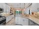 Bright kitchen features white cabinets, granite countertops, stone backsplash, and stainless steel appliances at 264 Line Creek Cir, Sharpsburg, GA 30277