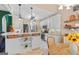 Open kitchen with stainless steel appliances, white cabinets, stone countertops, and adjacent breakfast nook at 264 Line Creek Cir, Sharpsburg, GA 30277