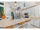 Spacious kitchen featuring granite countertops, stainless appliances, white cabinetry, and decorative light fixtures at 264 Line Creek Cir, Sharpsburg, GA 30277