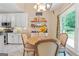 This kitchen has white cabinets, stainless steel appliances, granite countertops, and adjacent breakfast nook at 264 Line Creek Cir, Sharpsburg, GA 30277