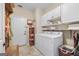 Laundry room and entryway featuring white washer and dryer, white cabinets and drop zone at 264 Line Creek Cir, Sharpsburg, GA 30277