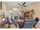 Cozy living room with fireplace, ceiling fan, and comfortable seating for a relaxing atmosphere at 264 Line Creek Cir, Sharpsburg, GA 30277