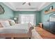 The main bedroom has tray ceilings, a ceiling fan, soft lighting, a comfortable bed, and natural light at 264 Line Creek Cir, Sharpsburg, GA 30277