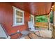 Covered porch with rocking chairs, a swing, and view of the private backyard at 264 Line Creek Cir, Sharpsburg, GA 30277