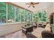 Sun room filled with wicker furniture, lots of windows and beautiful views of the backyard at 264 Line Creek Cir, Sharpsburg, GA 30277