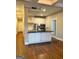 Well-lit kitchen with white cabinets, a granite island, and modern appliances at 2840 Peachtree Road Nw Nw Rd # 306, Atlanta, GA 30305