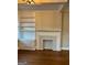 Cozy living room with a classic fireplace, built-in shelves, and hardwood floors at 2840 Peachtree Road Nw Nw Rd # 306, Atlanta, GA 30305