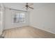 Bright bedroom featuring hardwood floors, a ceiling fan, and a window at 5207 Santa Fe Pkwy, Sandy Springs, GA 30350