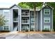 Exterior shot of a three-story apartment building with gray siding and white balconies at 5207 Santa Fe Pkwy, Sandy Springs, GA 30350