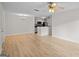Living room showcasing light wood flooring, and a view of the open kitchen at 5207 Santa Fe Pkwy, Sandy Springs, GA 30350