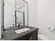 Modern bathroom featuring a sleek black vanity, a stylish sink, and a framed mirror for a contemporary look at 698 Eustace Se St, Atlanta, GA 30315