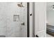 Modern bathroom shower with marble tiles, rainfall shower head, and a recessed shelf for toiletries at 698 Eustace Se St, Atlanta, GA 30315