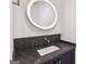 Elegant bathroom with a stylish vanity, circular backlit mirror, and a modern faucet, creating a spa-like atmosphere at 698 Eustace Se St, Atlanta, GA 30315
