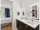 Modern bathroom with dual sinks, elegant fixtures, and access to the bedroom and closet at 698 Eustace Se St, Atlanta, GA 30315
