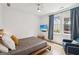 Bright bedroom with a large window, TV, ceiling fan, and minimalist decor for a clean, comfortable living space at 698 Eustace Se St, Atlanta, GA 30315