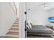 Modern bedroom with white walls, ceiling fan, and a comfortable bed, adjacent to the staircase at 698 Eustace Se St, Atlanta, GA 30315