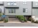 Gray townhome showcasing a garage, modern design with large windows, and landscaped entry with climbing ivy at 698 Eustace Se St, Atlanta, GA 30315
