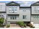 Modern townhome features a gray exterior, large windows, and attached garage with ivy climbing the facade at 698 Eustace Se St, Atlanta, GA 30315