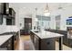 Open-concept kitchen featuring a large island, stainless steel appliances, and a view into the living area at 698 Eustace Se St, Atlanta, GA 30315