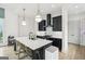 Modern kitchen with large island, white countertops, black cabinets, and stainless steel appliances at 698 Eustace Se St, Atlanta, GA 30315